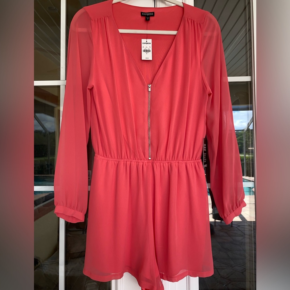 Long sleeve romper with pockets. Tags On. Never been worn.
